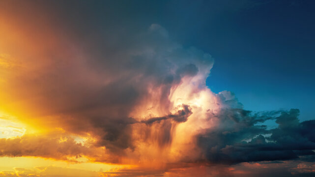 Dramatic storm clouds illuminated in vivid orange tones at sunset. A nature shot of a weather phenomenon.