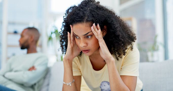 Argument, stress and woman on sofa in home with infidelity, cheating or toxic marriage with divorce. Upset, couple and female person in living room for disagreement in relationship with breakup.