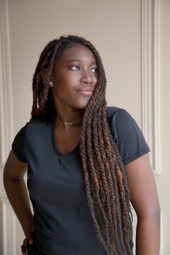 Confident young African woman portrait indoors, elegant lifestyle pose