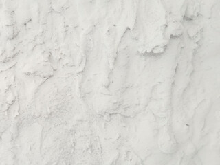 Obraz premium Close-up of a white salt surface with a crystalline rough texture. Natural abstract background with mineral structure.