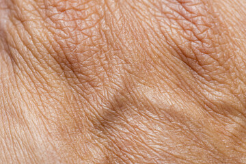 Fototapeta premium Macro Close-up Texture of Human Skin,A detailed macro photography shot capturing the natural texture, fine lines, and pores of human skin surface.