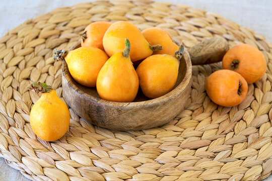 Fresh Loquat Fruits  in wooden bowl