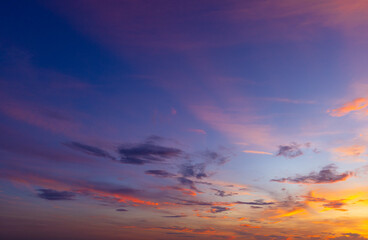 Fototapeta premium Dramatic golden hour sky with colorful sunset clouds,A breathtaking panoramic view of a dramatic golden hour sky, featuring vibrant orange, pink, and purple sunset clouds scattered across a deep blue 