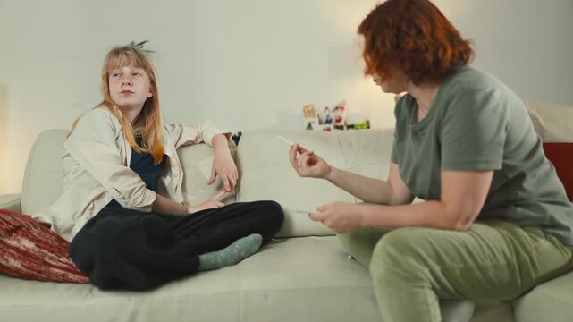 Mother discussing positive pregnancy test with teen daughter