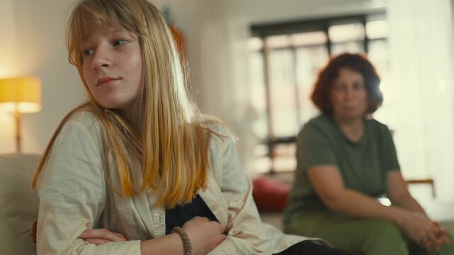 Frustrated teenager arguing with her mother at home