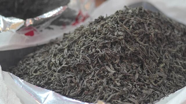 Green tea leaves are shown in a market in China