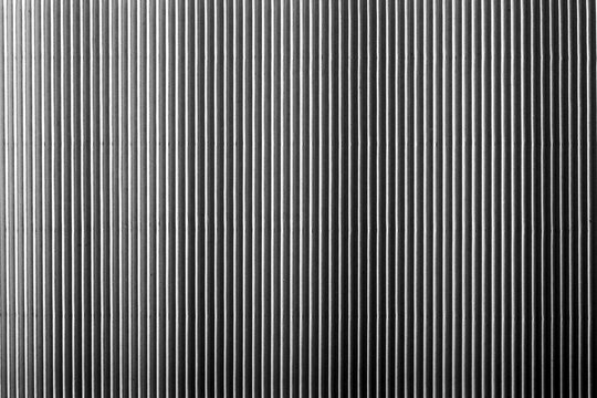 Monochrome vertical metal texture. Abstract striped surface with industrial look. Background for design and copy space..