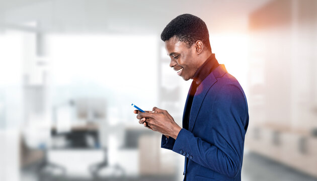 A person in a suit using a smartphone, shown in clean photographic style on bright office backdrop, concept of communication and business