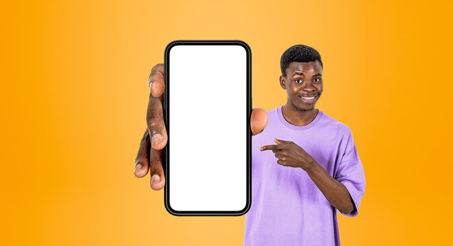 A person showing a smartphone with an empty screen in a clean photographic style on an orange backdrop, concept of mobile app display mockup scene