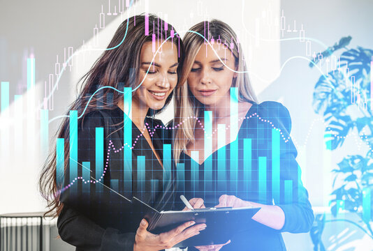 Two businesswomen studying documents with glowing financial charts overlay on a bright office background, concept of business analytics and growth