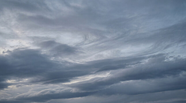Dynamic grey clouds with swirling patterns, conveying a moody and dramatic sky, ideal for intense weather concepts.