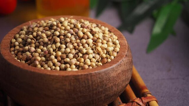 Cooking with coriander seeds in a wooden bowl
