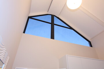 Fototapeta premium A high white ceiling, with a feature window and skylight. 