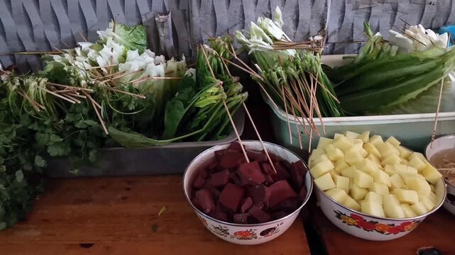 Assorted skewered vegetables at street food stall