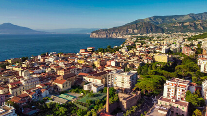 Fototapeta premium Cinematic drone view of Sorrento coastal town at sunset in Campania
