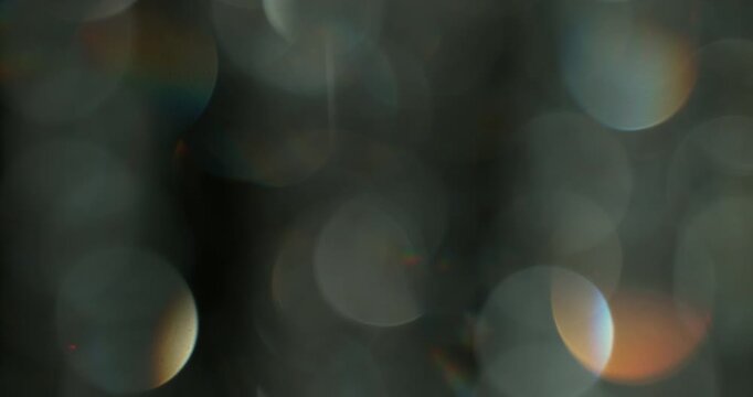 Slow motion of lens flare isolated on black background. Colored spectrum. Cinematic glowing light overlay with optical streaks and rays for VFX compositing and transitions.