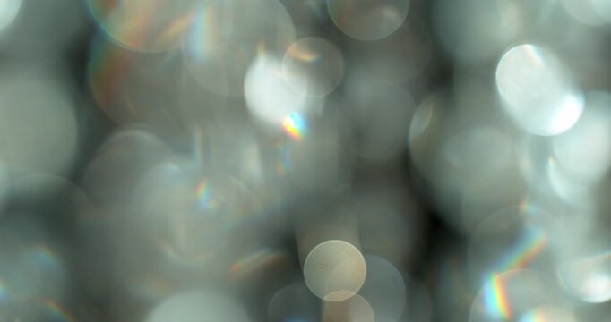 Slow motion of lens flare isolated on black background. Colored spectrum. Cinematic glowing light overlay with optical streaks and rays for VFX compositing and transitions.