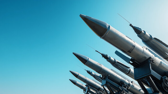 Military missiles lined up against clear blue sky, strategic defense technology concept, aerospace weapon system, national security, air defense readiness, tactical hardware and mo
