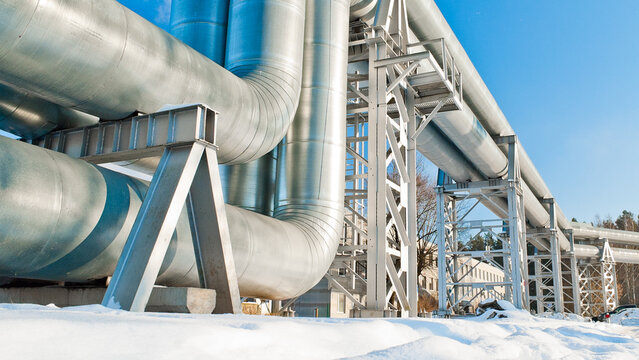 pipeline against the blue sky, snow in the foreground