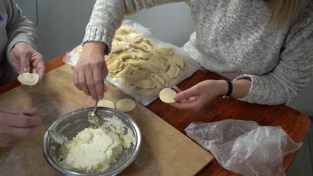 Hands making cheese dumplings. Cooking dough food at home.