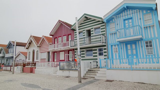 A slow panning shot showing the famous traditional colorful striped houses on the coast of Costa Nova in Portugal. 24.05.2026