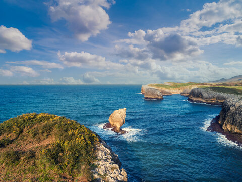 Aerial view on the rocky sea coast at sunrise. Buelna Beach (Playa Buelna), El Picon, Llanes, Asturias, Spain