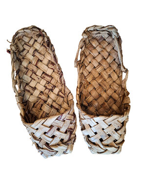 Bast shoes are woven from birch bark and feature a simple design. These shoes are a part of traditional Russian culture and reflect local craftsmanship and history.
