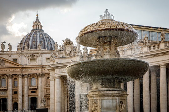 Fountain in Saint Peters Square with the Vatican Basilica dome