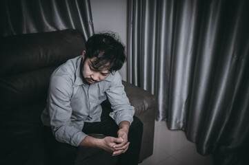 Obraz premium Asian handsome man stress from work overload,Tired male come back home after a lot of work from company,risk of depression