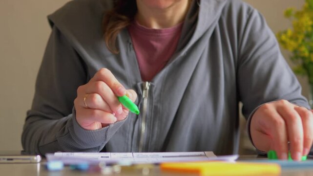 Highlighting Financial Documents Close Up &mdash; Hands Holding Green and Yellow Markers, Bookkeeping Audit, Desk Workspace and Business Paperwork Prep