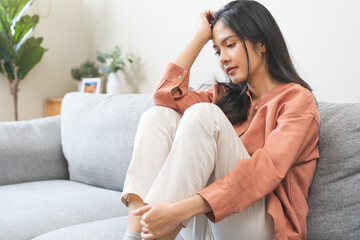 Obraz premium Sad, unhappy. Lonely asian young woman, girl expression face thinking about problem, difficulty, feeling failure and exhausted, suffering from loneliness, grief sorrow and bad relationship or break up