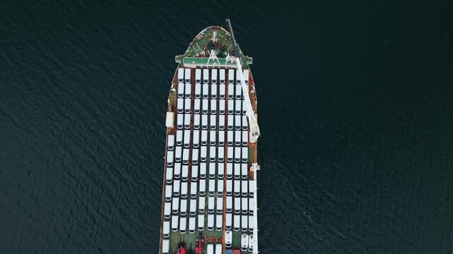 Top View A transport ship is loading cars at the port in Halifax, Nova Scotia. The activity showcases car export operations in a city known for shipping and trade