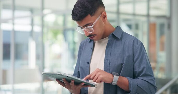 Man, typing and search in office with tablet, planning and online trend for social media marketing. Person, glasses and browsing in workplace with tech, website or creative idea for digital branding.