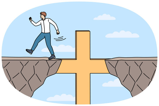 Religious business man overcomes obstacles thanks to christian crucifix and achieves goal. Guy corporate manager, is practicing catholic and achieves success in career using christian commandments.