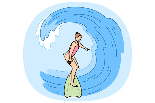 Woman surfer rides waves on surfboard, enjoying active summer holiday at seaside resort. Girl surfer does extreme sports during vacation, wanting to get adrenaline rush from surfing.