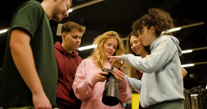 Group of friends meet at the fitness center to learn workout techniques and share tips on exercises during their training session