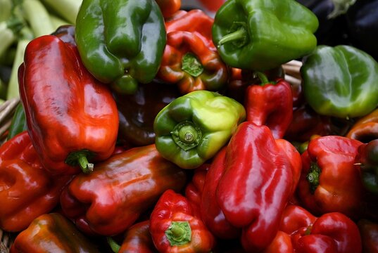 Fresh organic elongated green and red bell peppers on display at a local farmer's market in Catania Sicily, Italy.