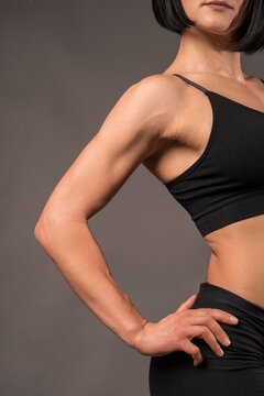 Toned bicep and shoulder definition of athletic woman