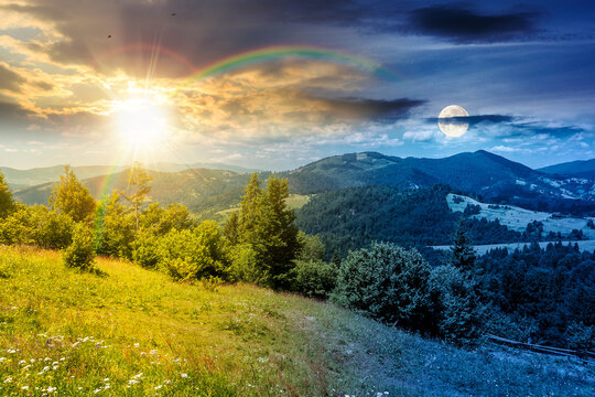 day meet night. agricultural field on hillside in mountains. sun and moon over carpathian mountain landscape on summer solstice. countryside view of alpine fields and rolling hills. epic sky