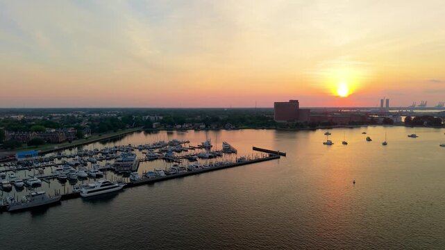Portsmouth, Virginia, scenic 4K aerial video establishing the historic Olde Towne waterfront and residential district along the Elizabeth River during a quiet golden hour sunset.