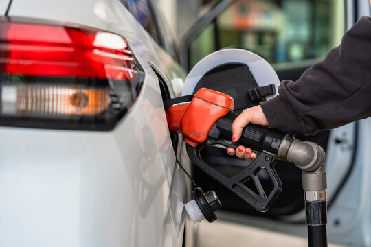 Close up hand gas station attendant refueled car with petrol, Concept travel and transportation.