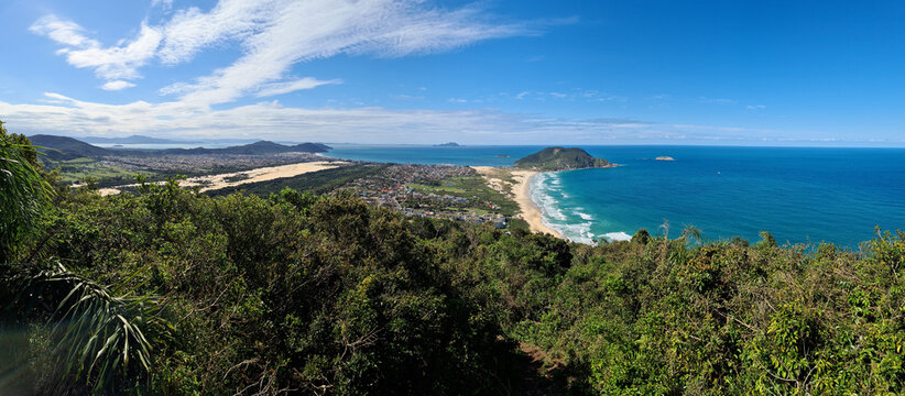 Panoramic view of Rio Vermelho and Ingleses district from Morro das Aranhas in Florianopolis, Brazil. Coastal landscape with Mocambique beach, dunes and mountains.