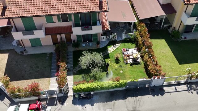 Drone shot of professional fumigation treatment in residential neighborhood green spaces