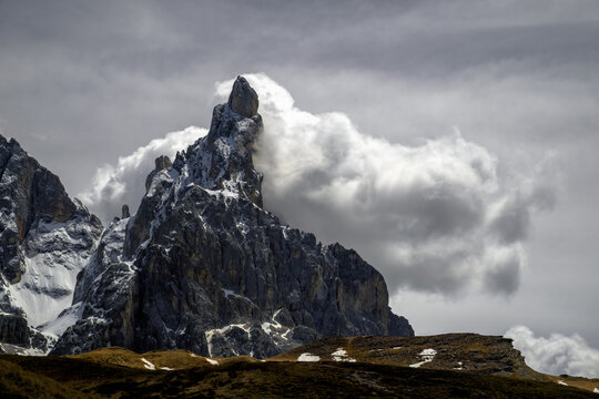 Cimon della Pala peak in the Dolomites Italy under dramatic clouds and storm light. Ideal for travel editorial adventure branding and nature conservation projects.