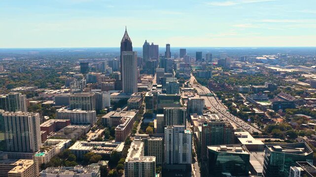 Atlanta city landscape with tall skyscraper buildings and roads with traffic. Fast urban rhythm, daily commute and metropolitan lifestyle.