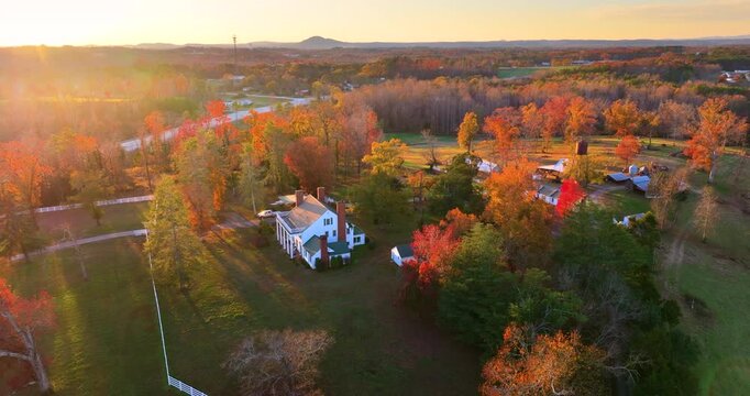 Rural estate houses between golden fall foliage in Appalachian countryside. Tranquil southern autumn atmosphere.