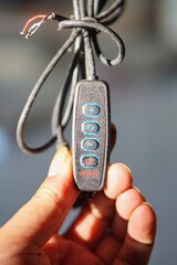 Detailed view of electronic device controller switch with light intensity plus minus buttons.