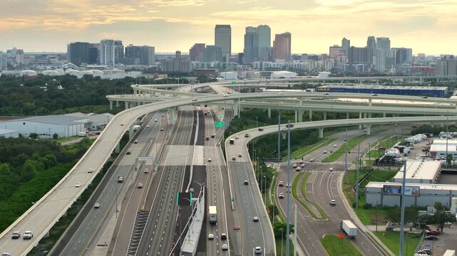 Tampa freeway interchange with elevated road lanes for fast express driving of cars. Vehicles driving on huge complex expressway junction.