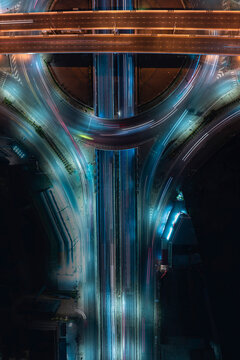 Abstract aerial highway scene with colorful motion blur traffic and modern infrastructure, ideal for smart city, ESG investment, sustainable mobility, and commercial backgrounds.