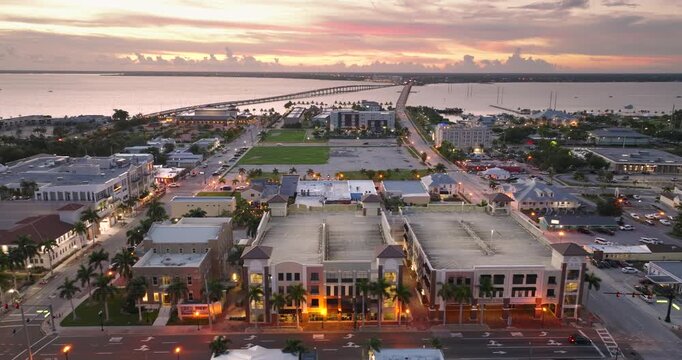 Scenic evening view of downtown Punta Gorda, Florida with illuminated storefronts, historic buildings and relaxed coastal town atmosphere.
